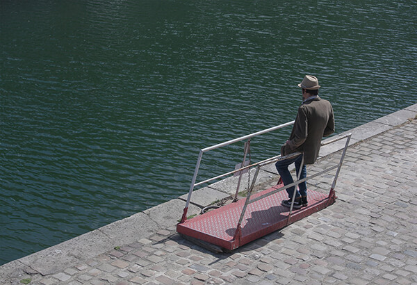 How to begin contemplative life. Man on boarding ramp to cross the water.